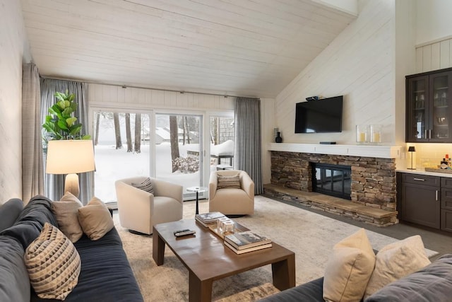 living room with lofted ceiling, a stone fireplace, light carpet, and a baseboard heating unit