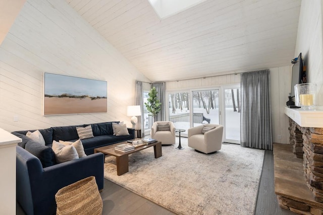 living room featuring hardwood / wood-style flooring, wood ceiling, a fireplace, and vaulted ceiling