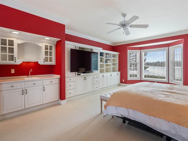 bedroom featuring light carpet, sink, and ornamental molding