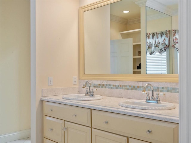 bathroom featuring vanity, crown molding, and decorative backsplash