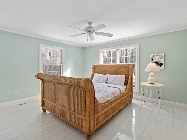 bedroom featuring multiple windows, crown molding, ceiling fan, and light hardwood / wood-style floors