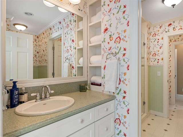 bathroom featuring tile patterned flooring, crown molding, vanity, and walk in shower