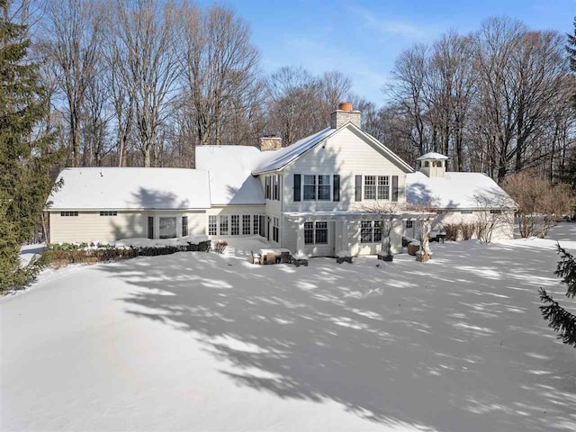 view of snow covered rear of property