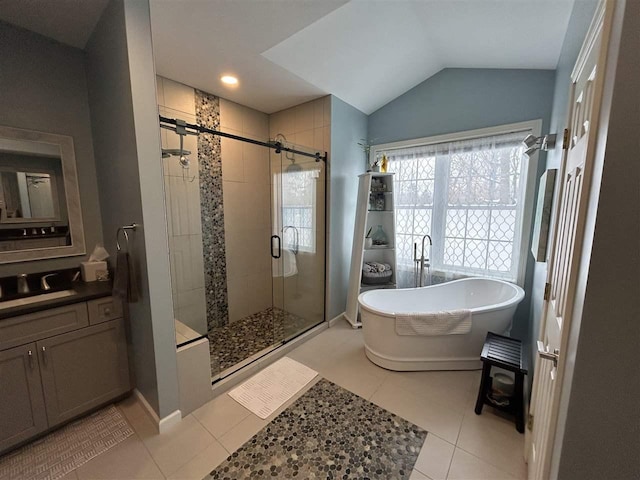 bathroom with lofted ceiling, vanity, tile patterned floors, and shower with separate bathtub