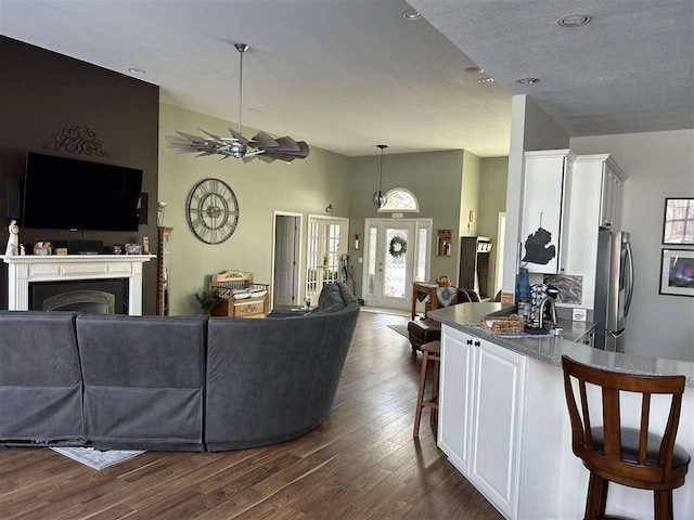 living room with dark hardwood / wood-style floors and vaulted ceiling