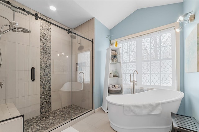 bathroom featuring lofted ceiling, independent shower and bath, and tile patterned flooring