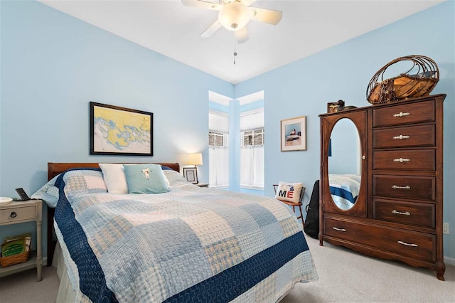 bedroom featuring light colored carpet and ceiling fan