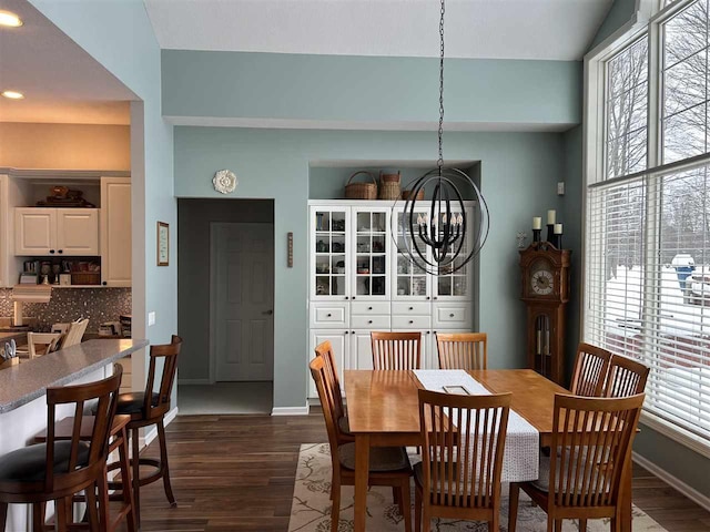 dining space with an inviting chandelier, dark hardwood / wood-style floors, and a wealth of natural light