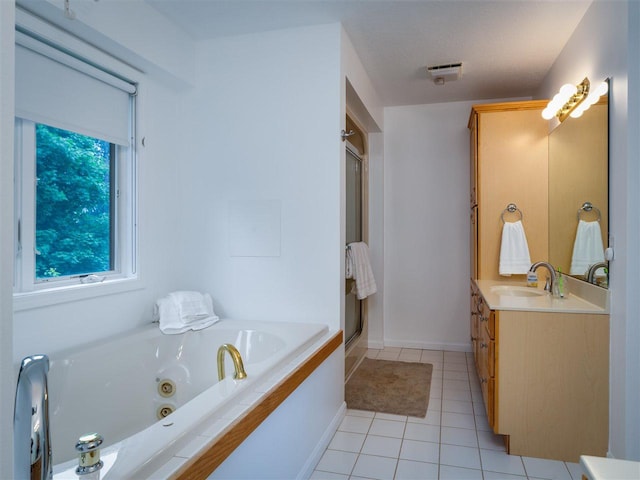 bathroom featuring vanity, plus walk in shower, and tile patterned flooring