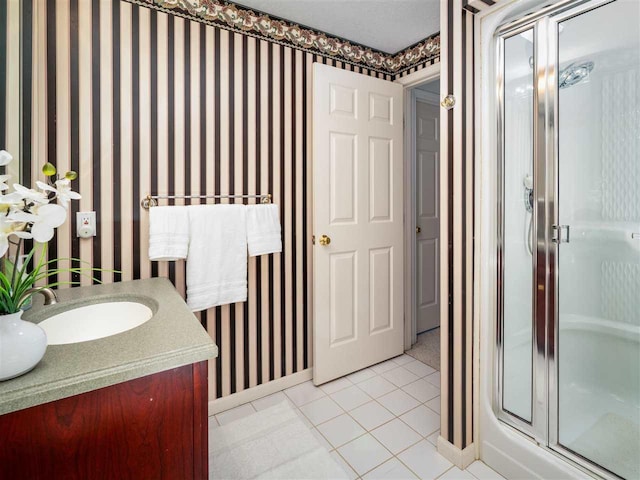 bathroom featuring vanity, a shower with door, and tile patterned flooring