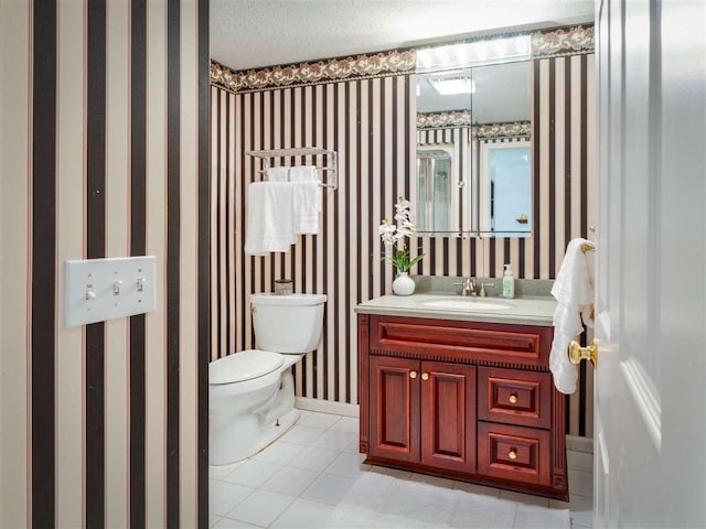 bathroom featuring tile patterned floors, vanity, toilet, and a textured ceiling