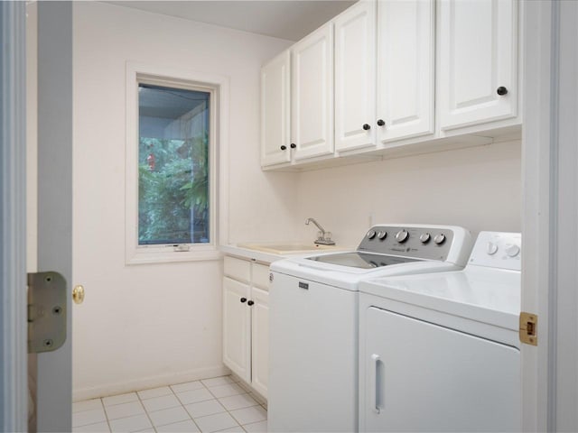 washroom featuring cabinets, washer and clothes dryer, sink, and light tile patterned floors