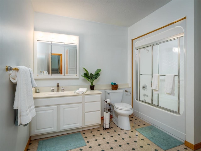 full bathroom featuring vanity, shower / bath combination with glass door, and toilet