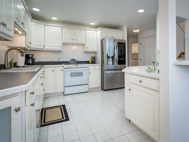 kitchen featuring stainless steel refrigerator with ice dispenser, white range with electric cooktop, sink, and white cabinets