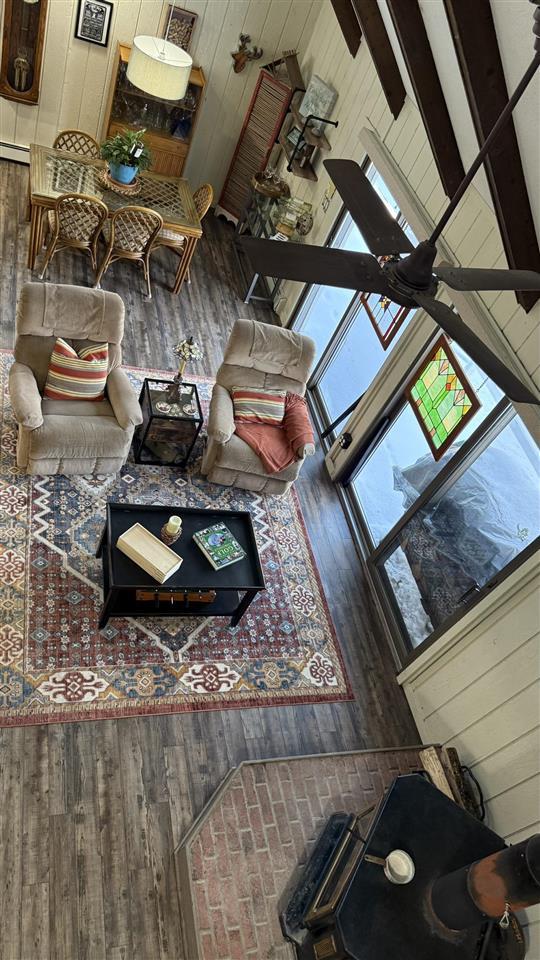 living area featuring wood walls and wood finished floors