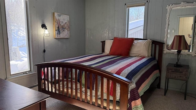 bedroom featuring wood walls and carpet