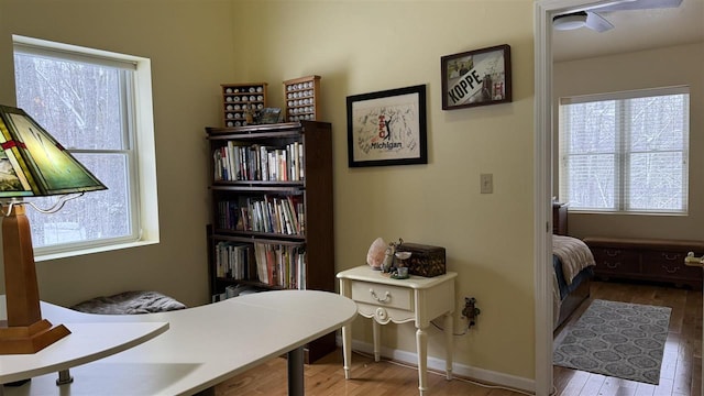 office area featuring baseboards and wood finished floors