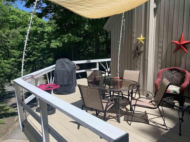 deck with outdoor dining area