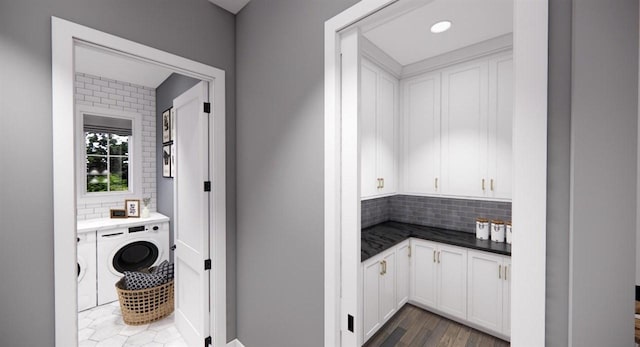 laundry area featuring dark wood-type flooring and washer / dryer