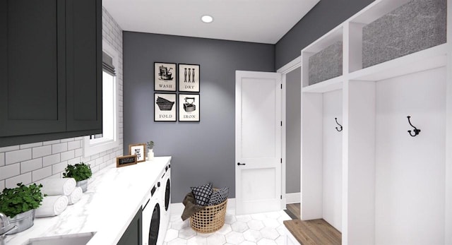 bathroom featuring tasteful backsplash, washing machine and clothes dryer, and wood-type flooring