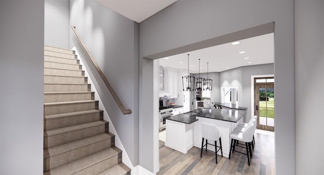 stairway with wood-type flooring and sink