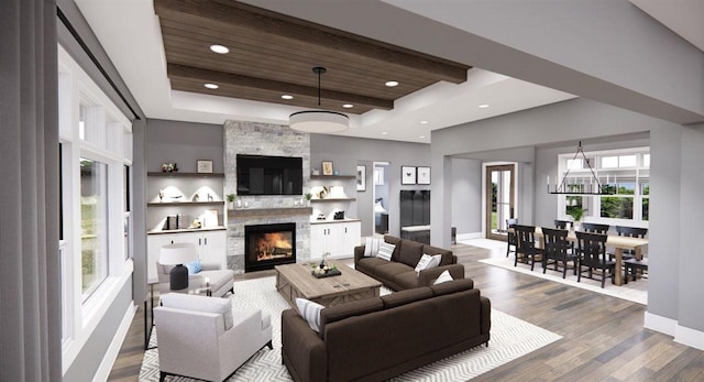 living room featuring a tray ceiling, a stone fireplace, wood-type flooring, and wooden ceiling