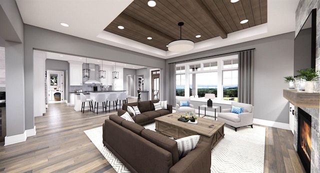 living room with hardwood / wood-style flooring, a tray ceiling, and wooden ceiling