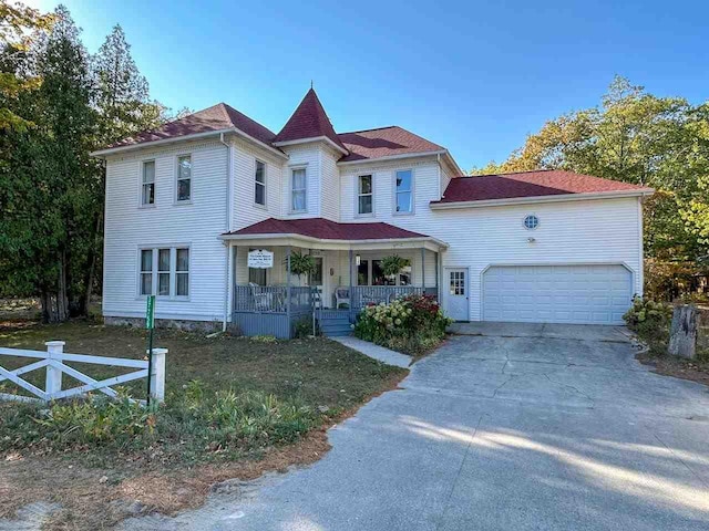 view of front facade with a garage and covered porch