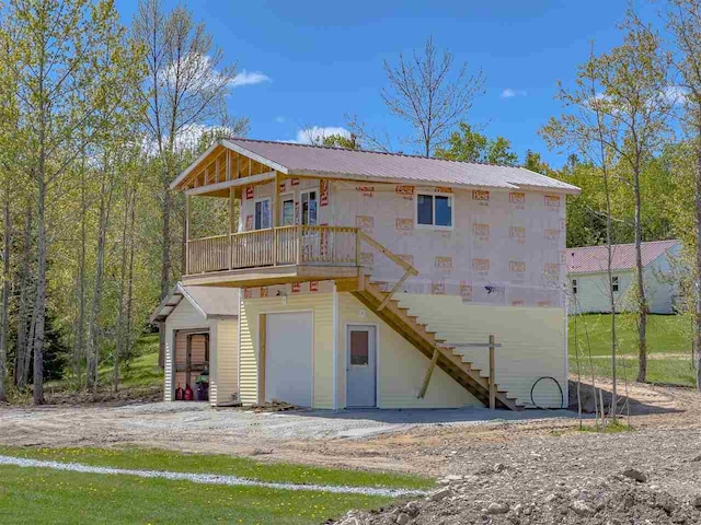 rear view of house featuring a garage