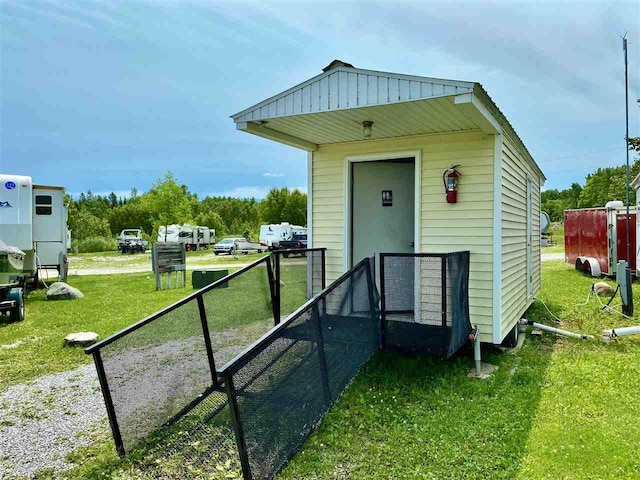 view of outbuilding featuring a lawn