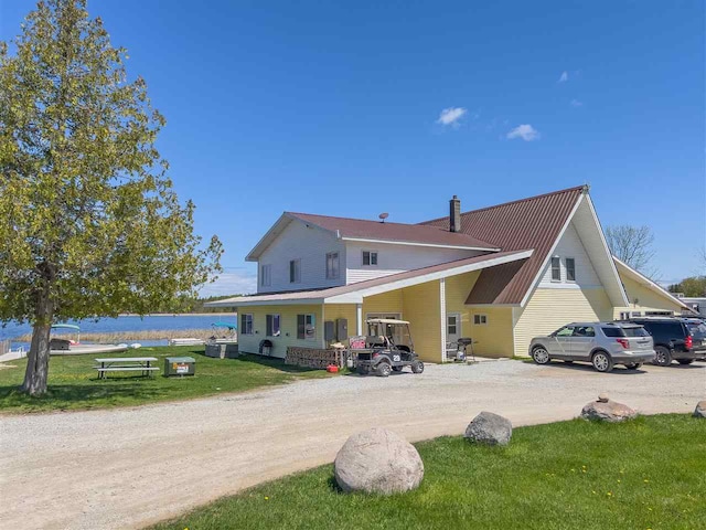 back of house with a lawn