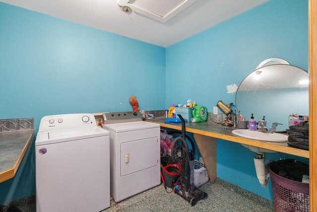 clothes washing area featuring sink and washing machine and dryer