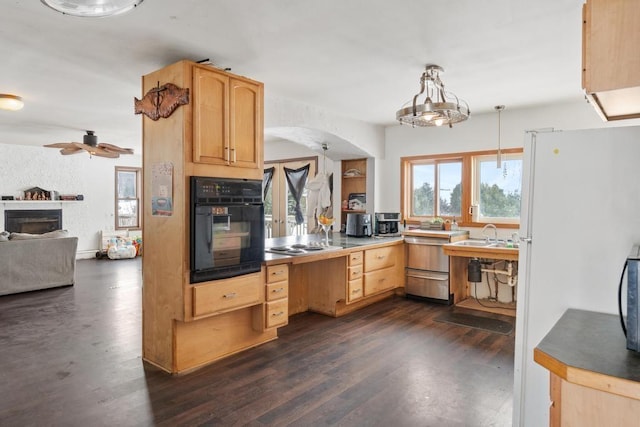 kitchen with dark hardwood / wood-style flooring, decorative light fixtures, light brown cabinetry, and black appliances