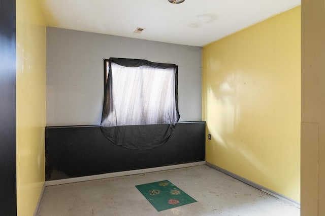 spare room with concrete floors