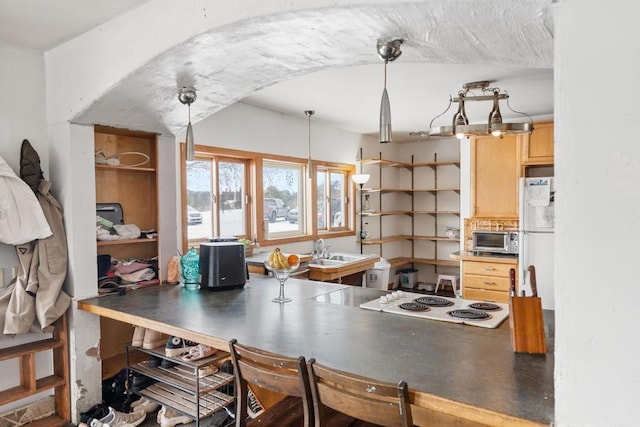 kitchen with white appliances, sink, hanging light fixtures, and light brown cabinets