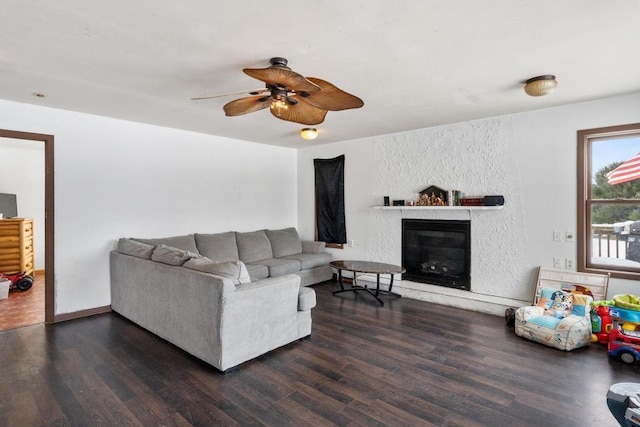 living room featuring dark wood-type flooring and ceiling fan