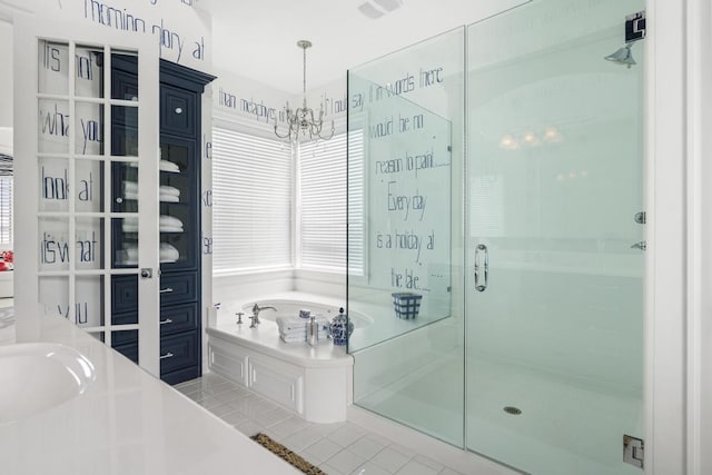 bathroom featuring separate shower and tub, sink, and a notable chandelier