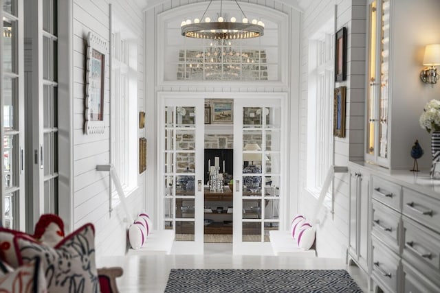 interior space featuring french doors and a chandelier