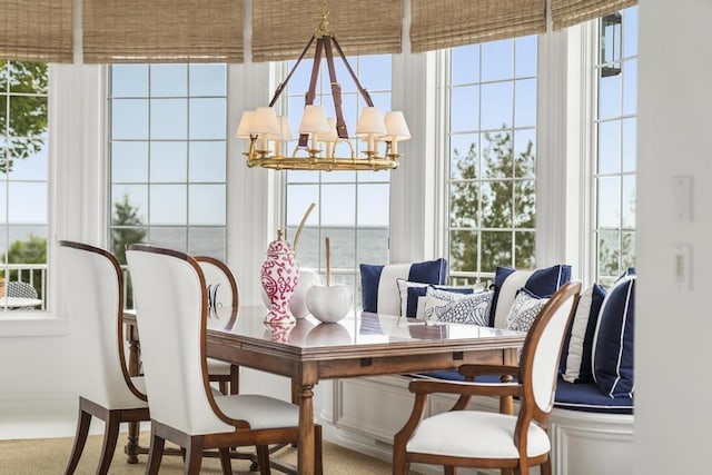 sunroom / solarium with a wealth of natural light and an inviting chandelier