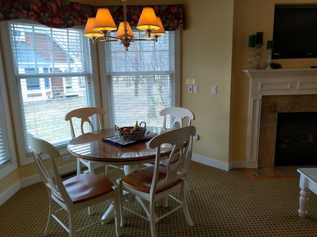 dining room featuring a high end fireplace and a notable chandelier