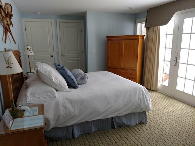 carpeted bedroom with multiple windows