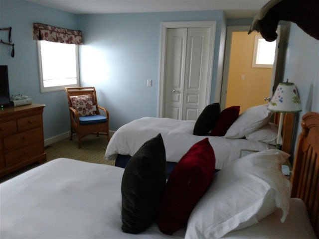 carpeted bedroom featuring a closet