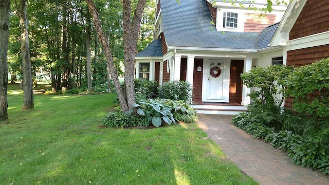 doorway to property featuring a yard