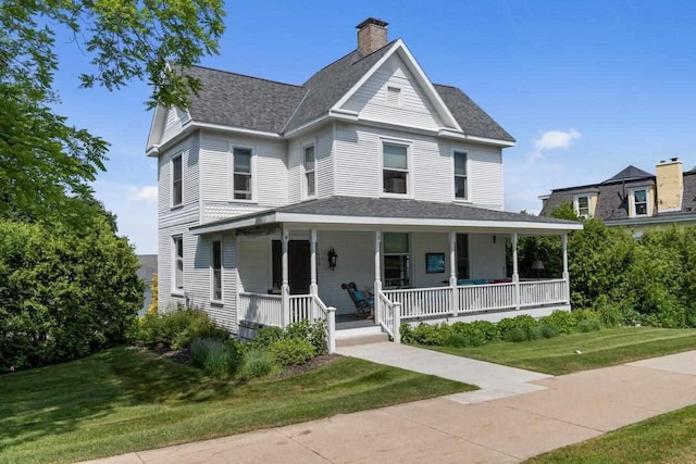 view of front facade with covered porch and a front lawn