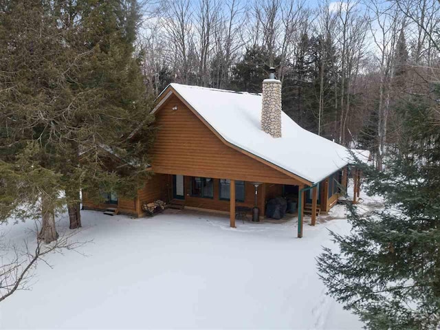 view of snow covered rear of property