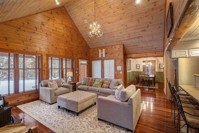 living room with light hardwood / wood-style flooring, wooden walls, and a chandelier