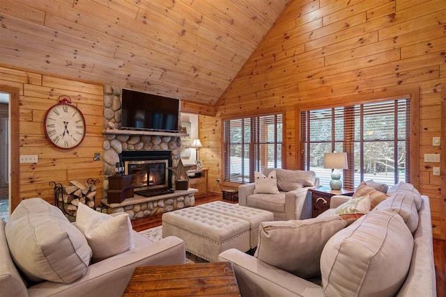 living room with wood-type flooring, a fireplace, wooden walls, and a healthy amount of sunlight