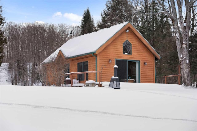 view of snow covered rear of property