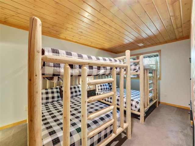 carpeted bedroom with wood ceiling