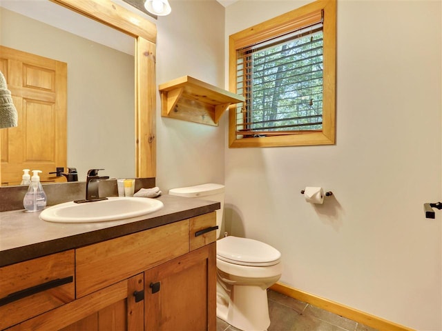 bathroom featuring tile patterned floors, vanity, and toilet